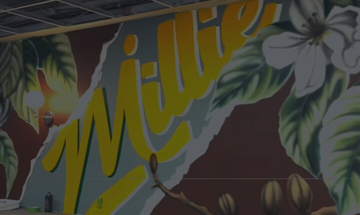 The hand-painted mural and gold Millie's script